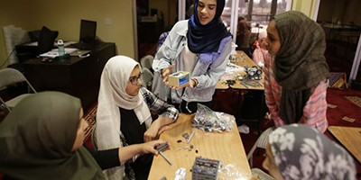 FemSTEM students work on the team robot for FIRST LEGO League.