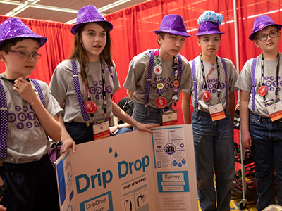 FIRST LEGO League team “The Dots” present to judges at FIRST Championship Detroit
