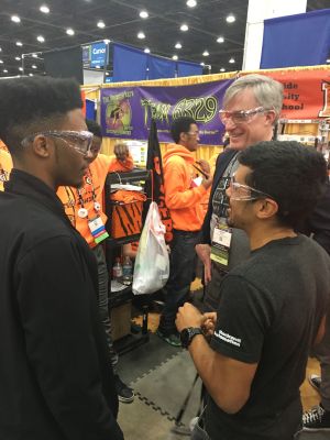 Javion speaks with Rockwell Automation representatives at the FIRST Championship.