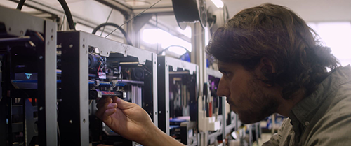 Jonathan Schwartz works on a 3-D printer at Voodoo.
