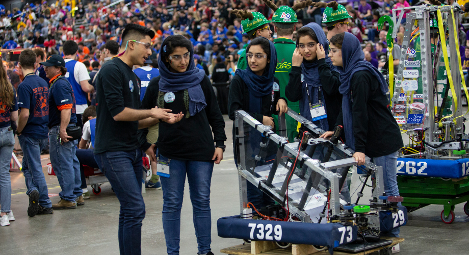 Students from FIRST Robotics Competition team “The Afghan Dreamers” prepare with their mentor before a match at the 2018 FIRST Championship in Detroit.
