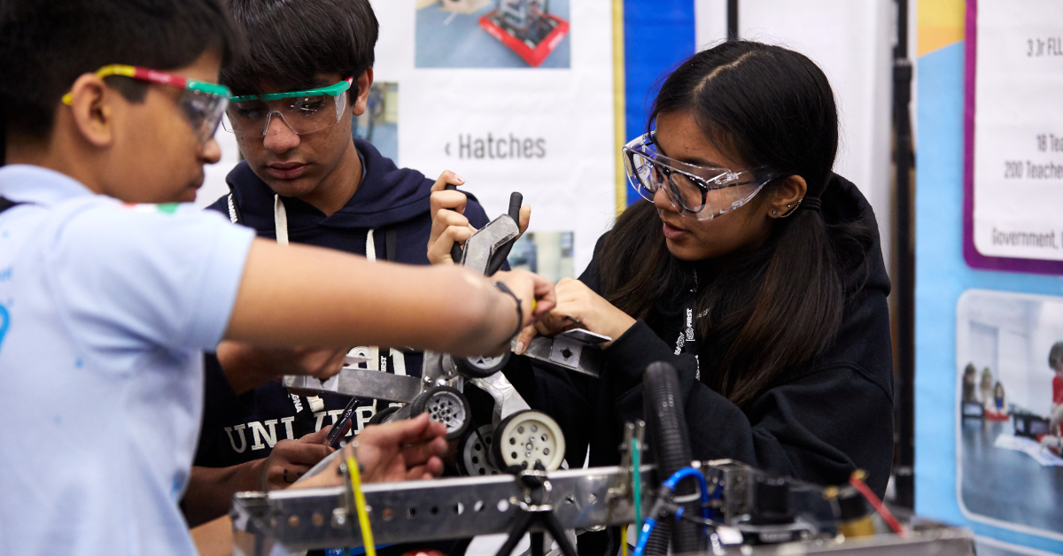 three students build a robot
