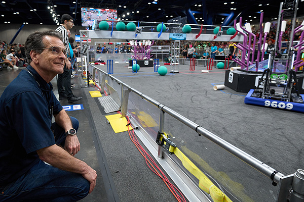 FIRST Founder Dean Kamen observes a FIRST Robotics Competition REEFSCAPE match.