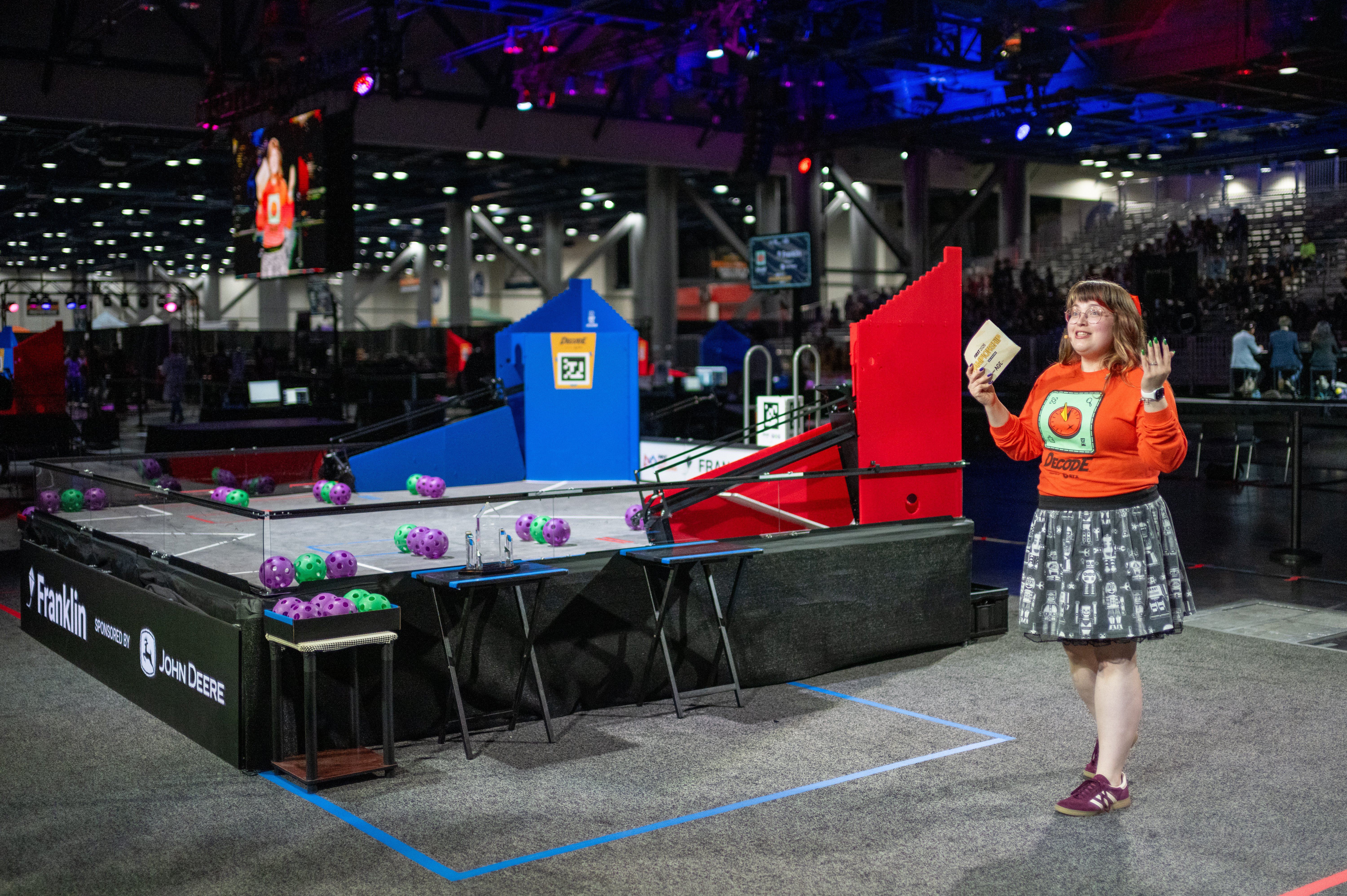 FIRST event volunteer shares exciting news with the crowd at FIRST Championship