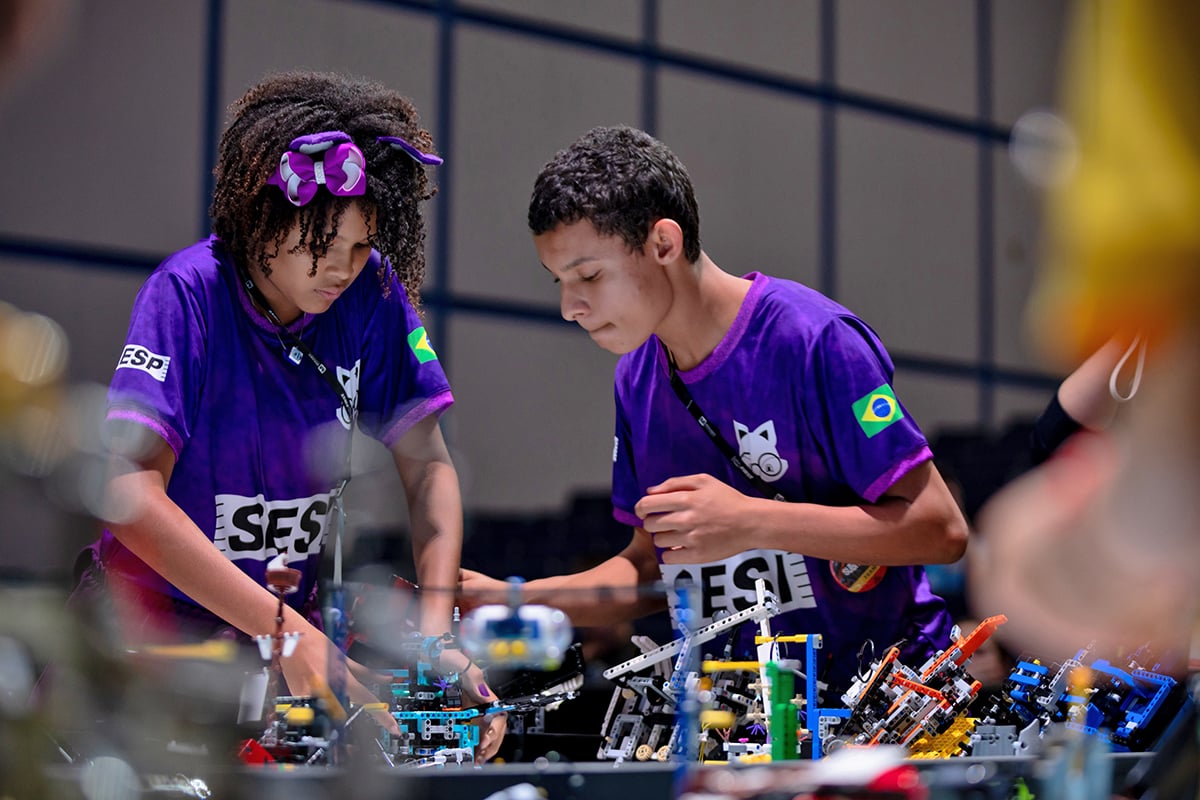 Two FIRST LEGO League student setting up robot to compete in FIRST LEGO League Challenge at FIRST Championship.