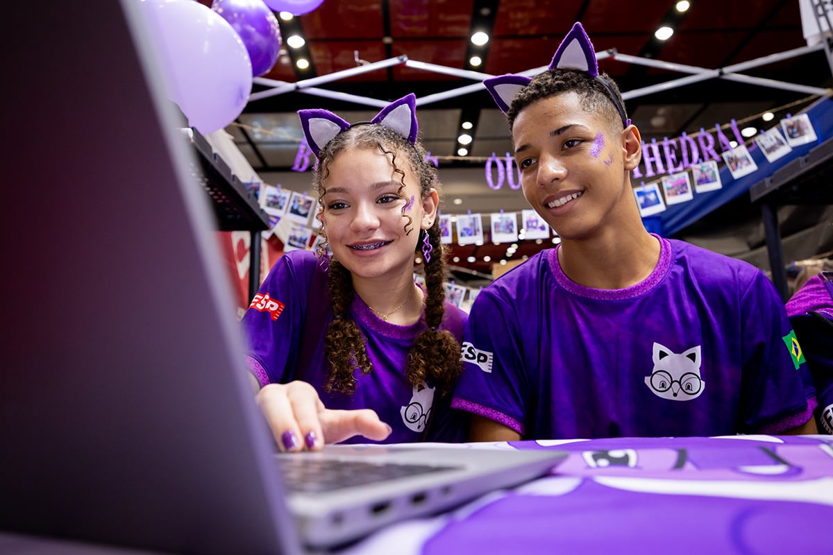 Two FIRST LEGO League students programming their robot at FIRST Championship.