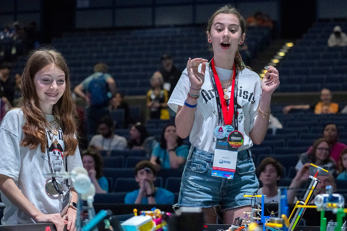 Two FIRST LEGO League students cheering on their robot at FIRST Championship.