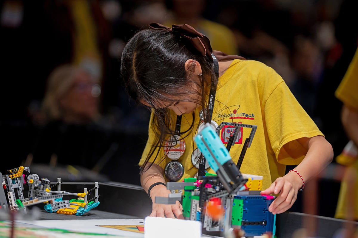 FIRST LEGO League student participant setting up robot at 2026 FIRST Championship