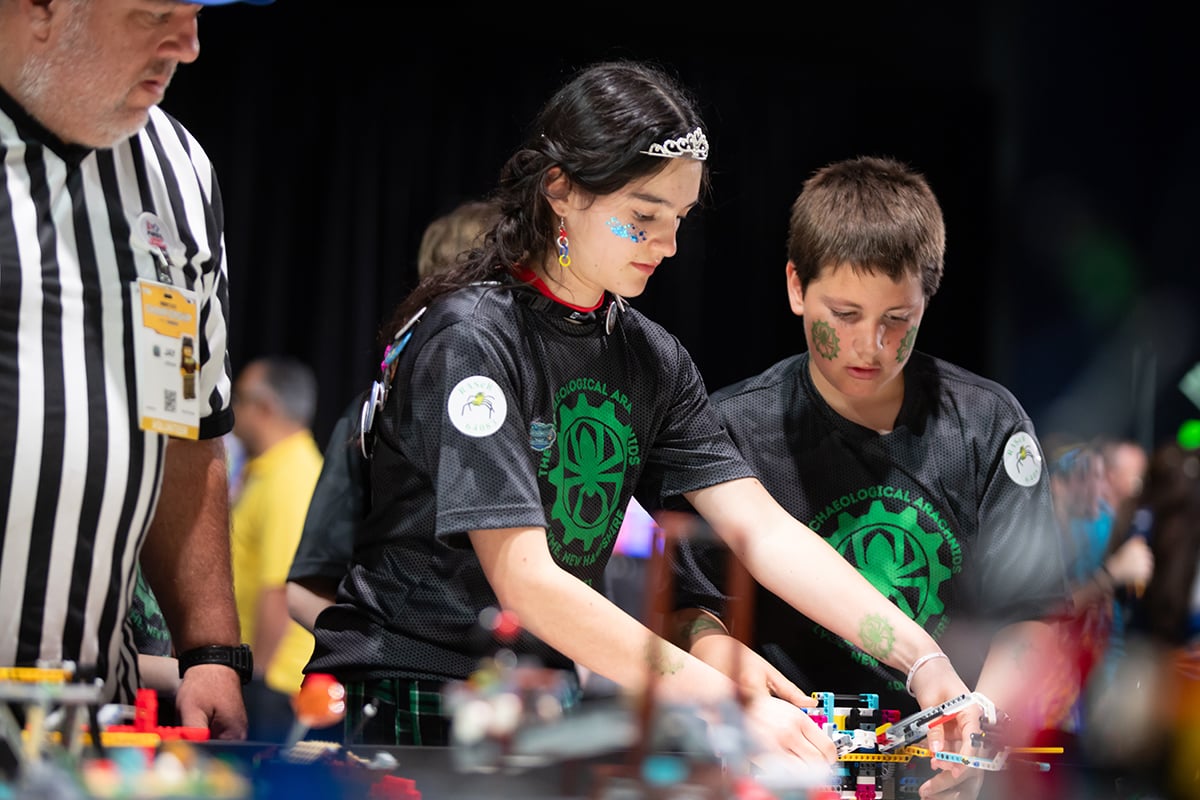 FIRST LEGO League student participants setting up robot at 2026 FIRST Championship