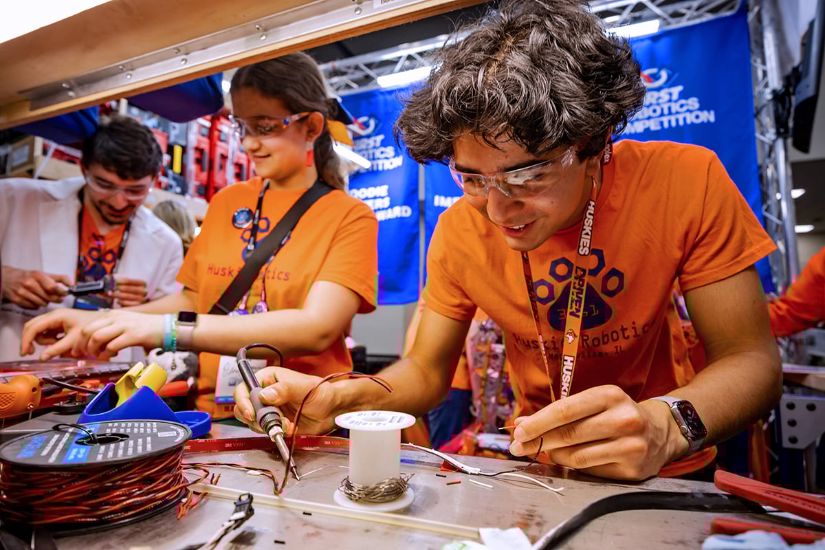 FIRST Robotics Competition students working on their robot at FIRST Championship