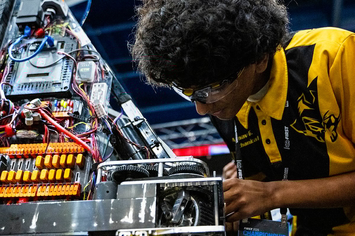 FIRST Robotics Competition student working on their robot at FIRST Championship