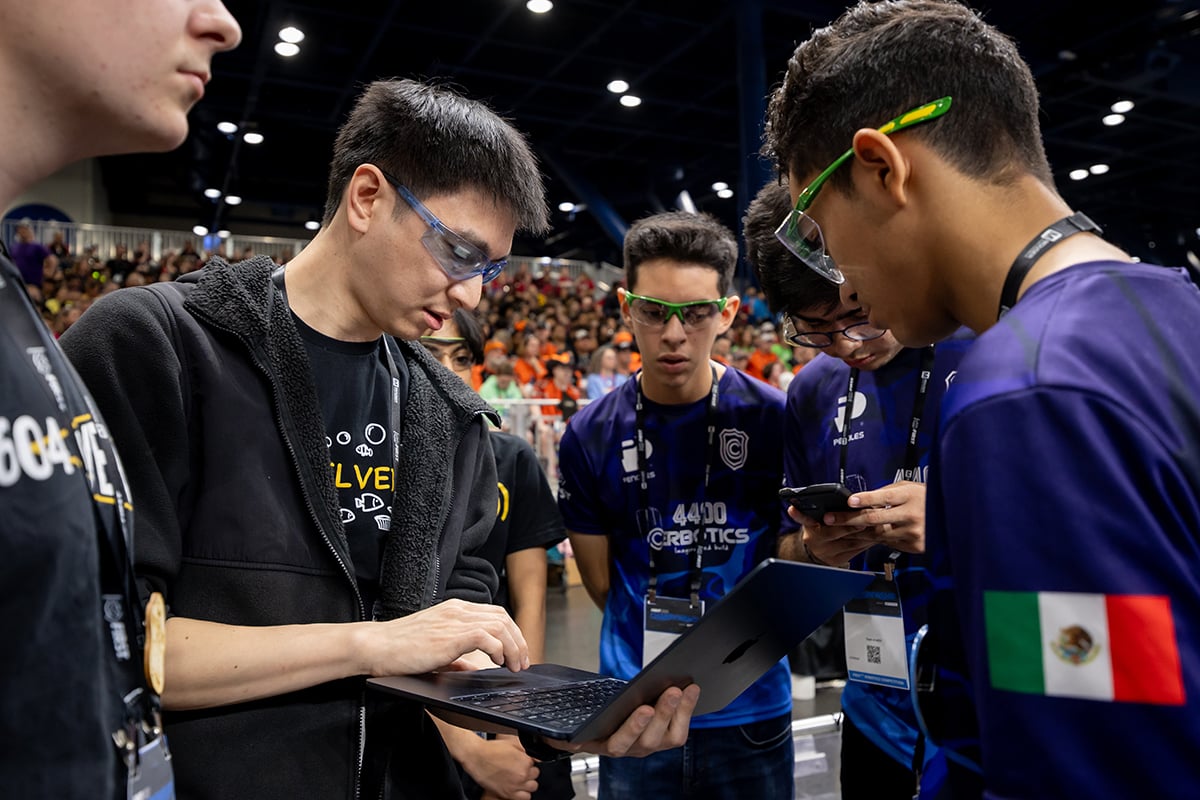 Two FIRST Robotics Competition teams discussing strategy at FIRST Championship