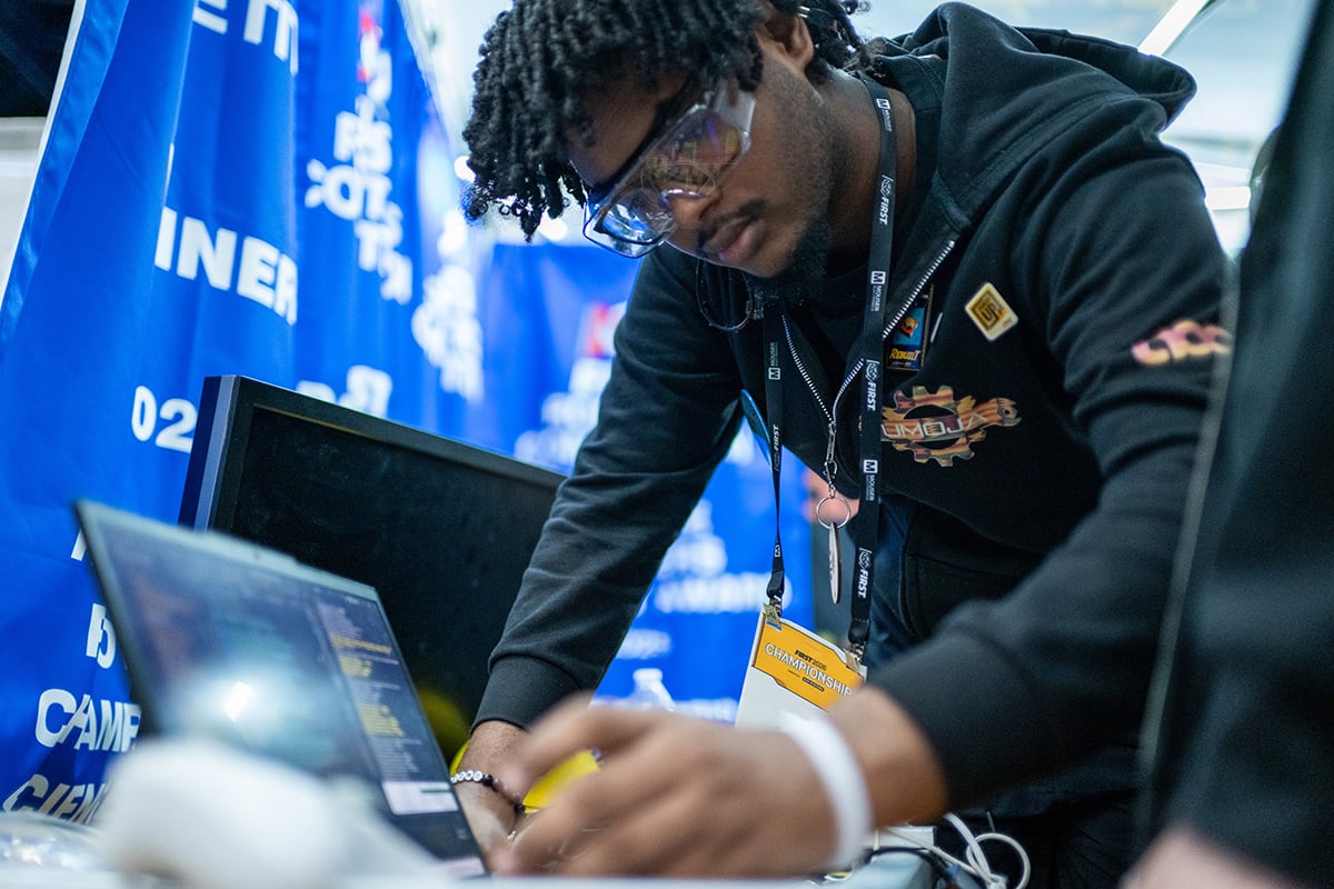Student programs robot at the 2026 FIRST Championship