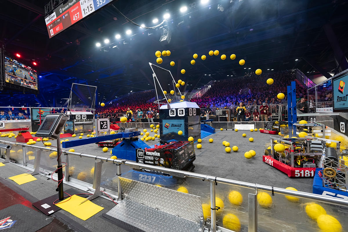 FIRST Robotics Competition robots scoring game objects at the 2026 FIRST Championship