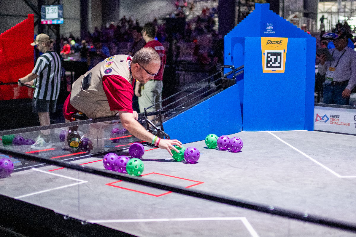 FIRST Tech Challenge event volunteer setting up field at 2026 FIRST Championship