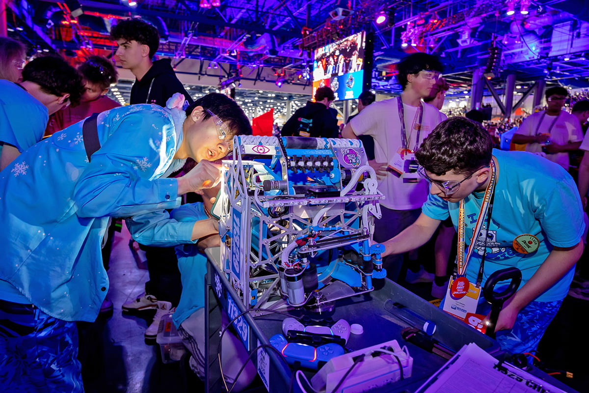 FIRST Tech Challenge student participants working on robots in pits at 2026 FIRST Championship