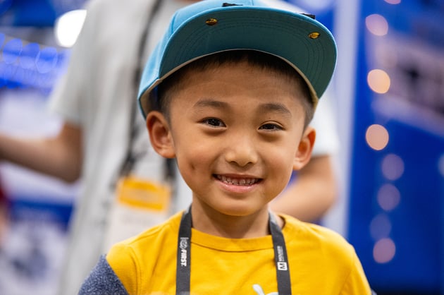 A young child smiles while attending the 2026 FIRST Championship.