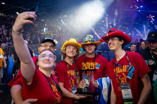 students celebrating with a selfie after winning the event
