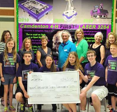 Members of Camdenton's FIRST teams accept a grant from a local community organization.