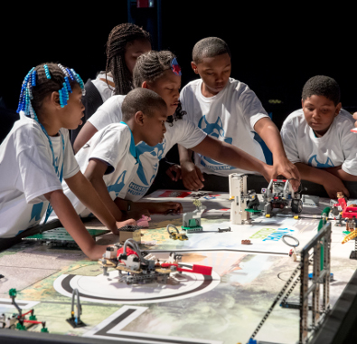 Kids working on a FIRST LEGO League robot