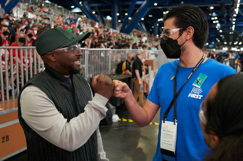 will.i.am prepares to address the crowd before the start of a FIRST Robotics Competition match on April 22 at the 2022 FIRST Championship in Houston.