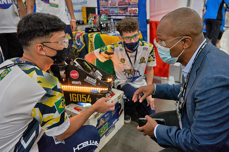 FIRST CEO Chris Moore meets with a FIRST Tech Challenge team during the 2022 FIRST Championship on April 21 in Houston. 