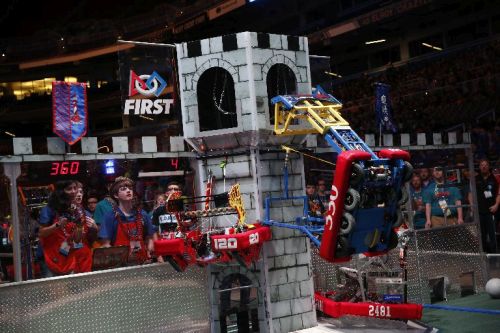 Figure 1. Robots built by high-school students on FIRST Robotics Competition teams climb a tower to earn points as part of a theme-based floor game. (Source: Adriana M. Groisman, courtesy of FIRST.)