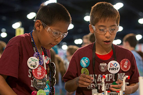 Figure 2. FIRST LEGO League, for students in grades 4–8, challenges teams to research a real-world engineering problem, develop a solution, and compete on a playing field with LEGO MINDSTORMS robots of their own design. (Source: Dan Donovan, courtesy of FIRST.)