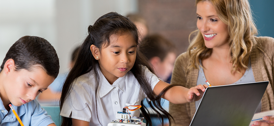 Teacher with students on computer