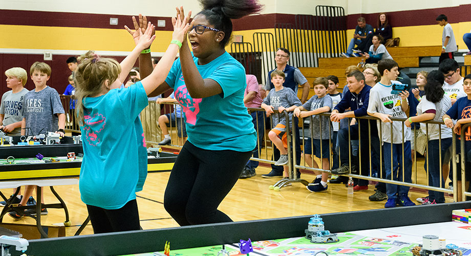 The Brainiac Maniacs celebrate during a FIRST LEGO League match.