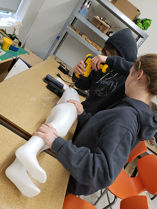 SStudents build a flying robot using FIRST Tech Challenge robot parts and a plastic mannequin.