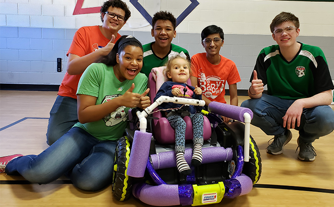 Lexi Dixon, Aiden Jacobs, Sola Dugbo, Aasim Hawa and Sean Mathews celebrate Brooklynn’s ability to move on her own for the first time at GoBabyGo - FIRST Community Build on November 23, 2019.