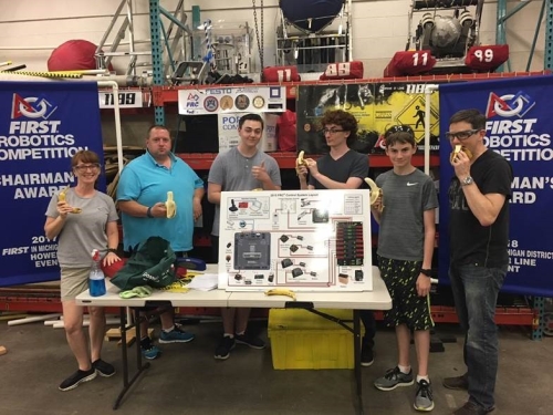 FIRST Robotics Competition Team 1189 with their Control System Board and bananas