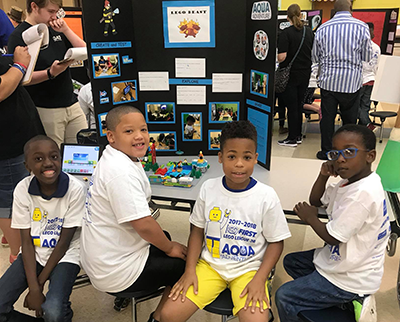 A FIRST LEGO League Jr. team from YouthLink STEM Academy in South Carolina attend an expo.